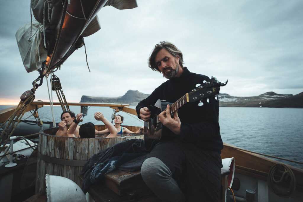 Captain Heimir playing guitar by Asa Steinars