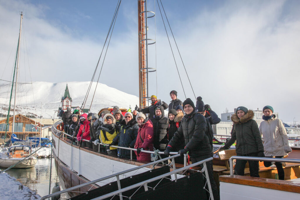 Passengers on board traditional Icelandic oak boat happy after having seen Orcas in Húsavík