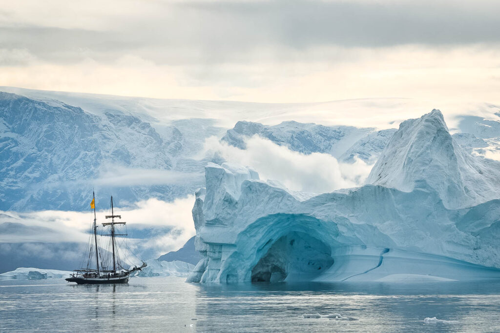 Sailboat Opal next to iceberg