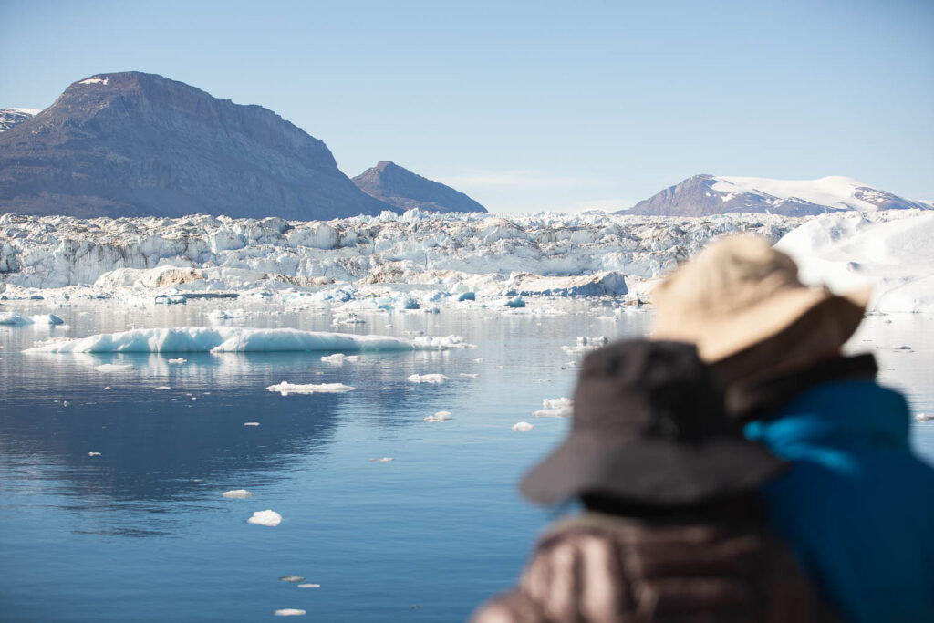 Passengers admiring the beautiful fjord filled with icebergs