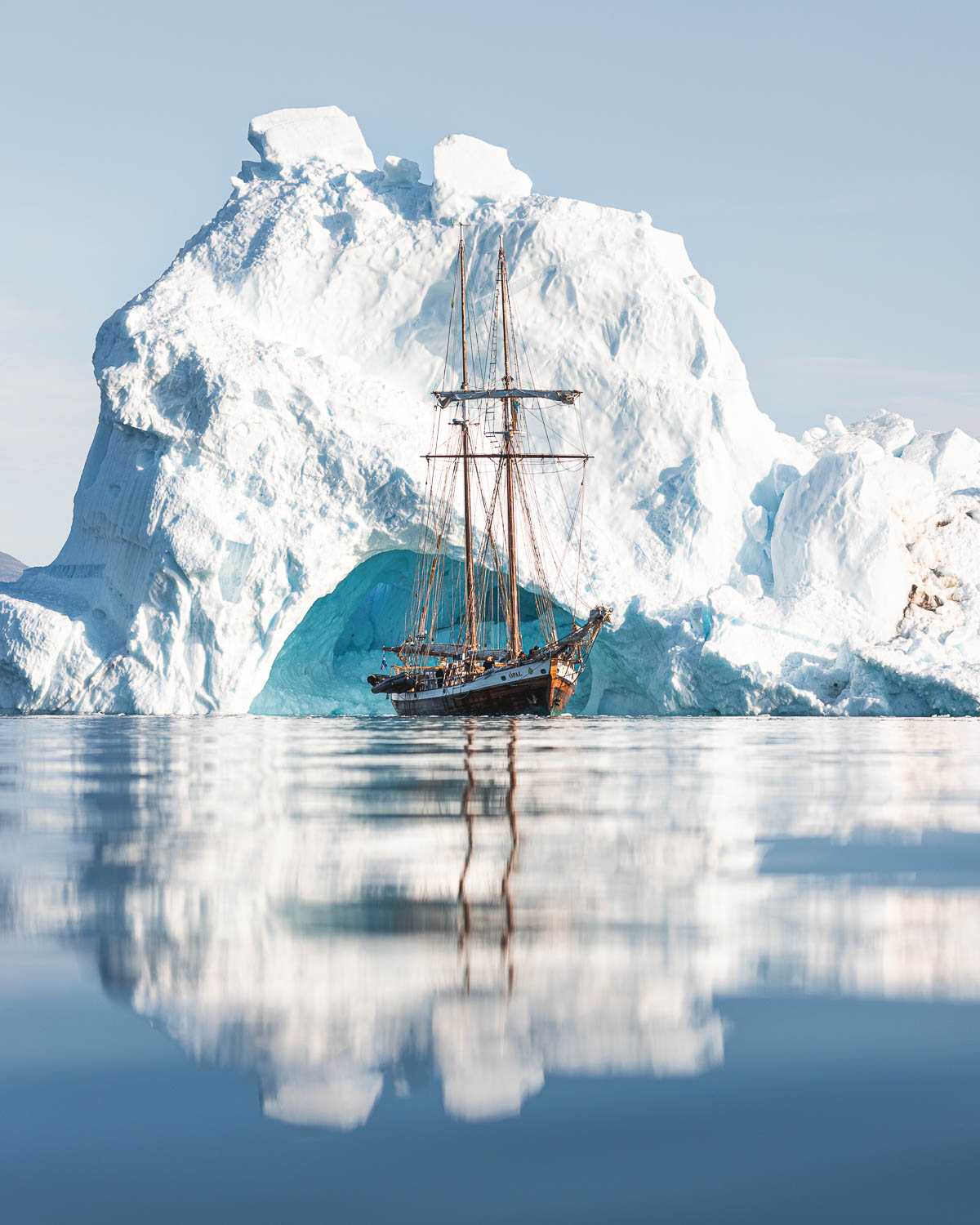 Schooner Opal in front of huge iceberg
