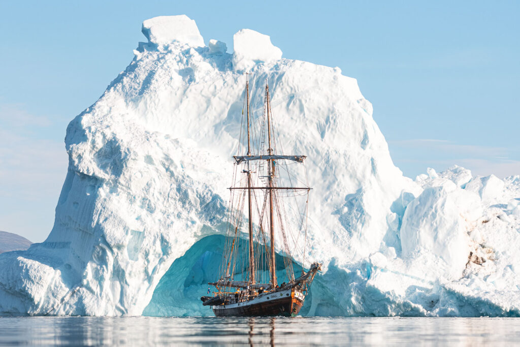 Schooner Opal next to iceberg in East Greenland